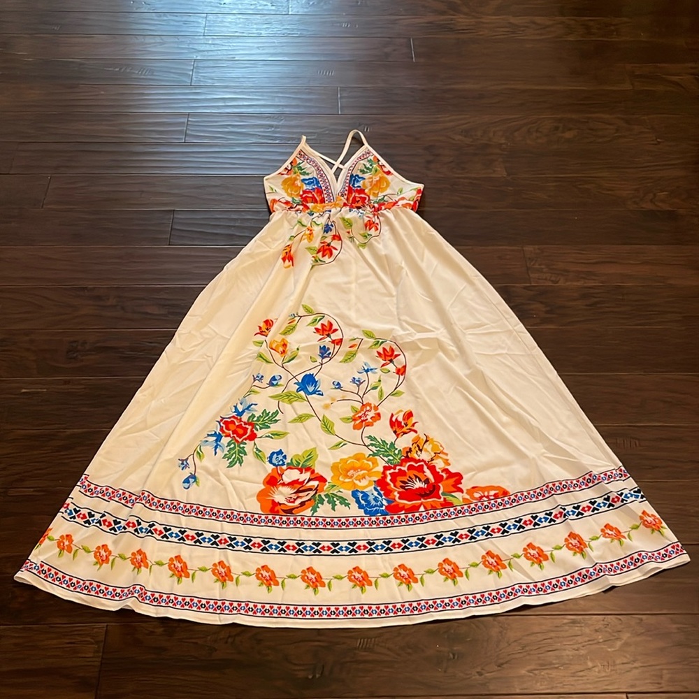 Never worn size medium long sundress. Criss cross adjustable straps in back